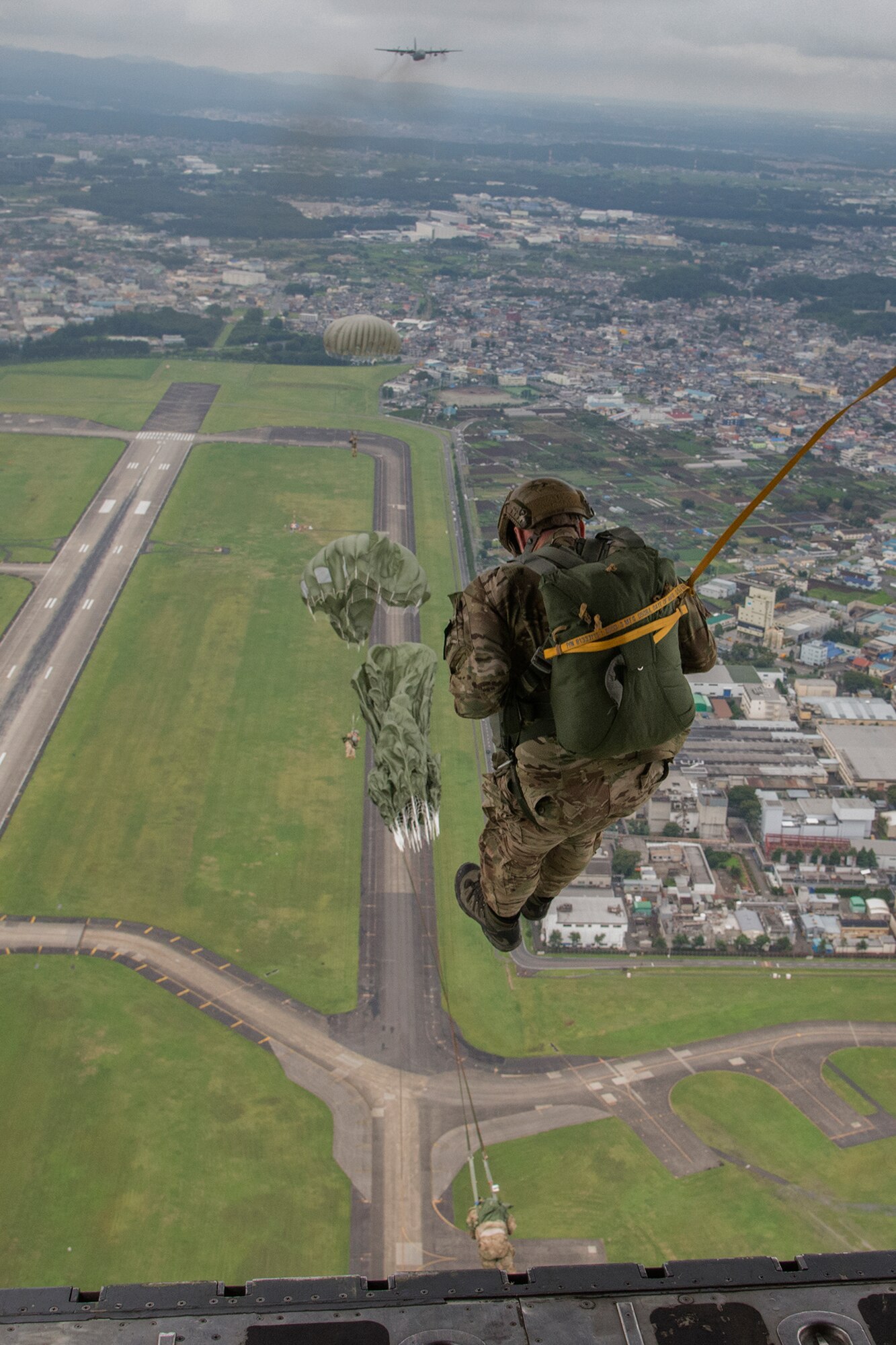 U.S. Soldiers with the 1st Battalion, 1st Special Forces Group (Airborne) conduct an airdrop jump demonstration from a C-130 Hercules over Yokota Air Base, Japan, during the Japanese-American Friendship Festival Sept. 7, 2014. Yokota welcomed approximately 148,000 visitors during the two-day festival. (U.S. Air Force photo by Senior Airman Michael Washburn/Released)
