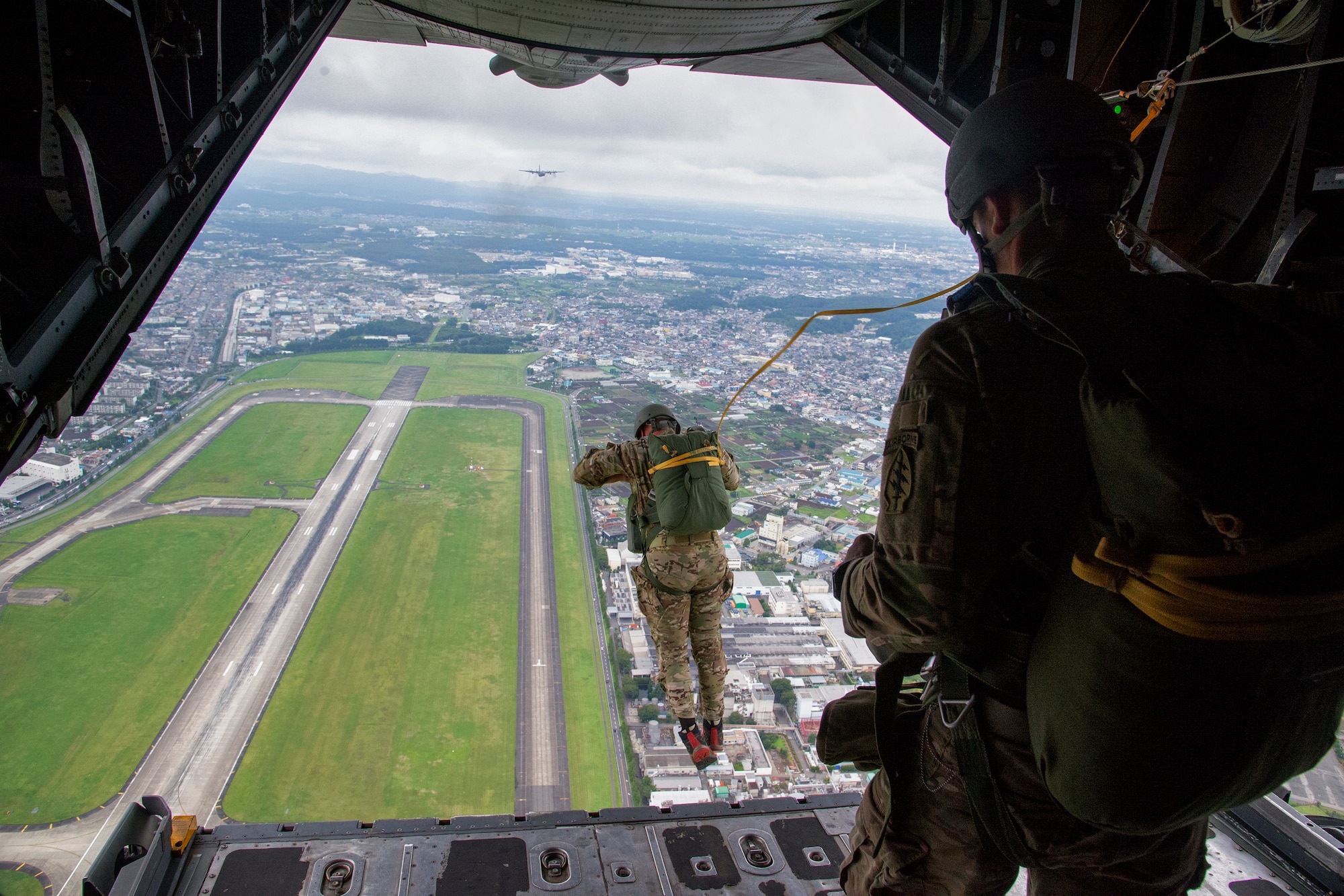 U.S. Soldiers with the 1st Battalion, 1st Special Forces Group (Airborne) conduct an airdrop jump demonstration from a C-130 Hercules over Yokota Air Base, Japan, during the Japanese-American Friendship Festival Sept. 7, 2014. Yokota welcomed approximately 148,000 visitors during the two-day festival. (U.S. Air Force photo by Senior Airman Michael Washburn/Released)