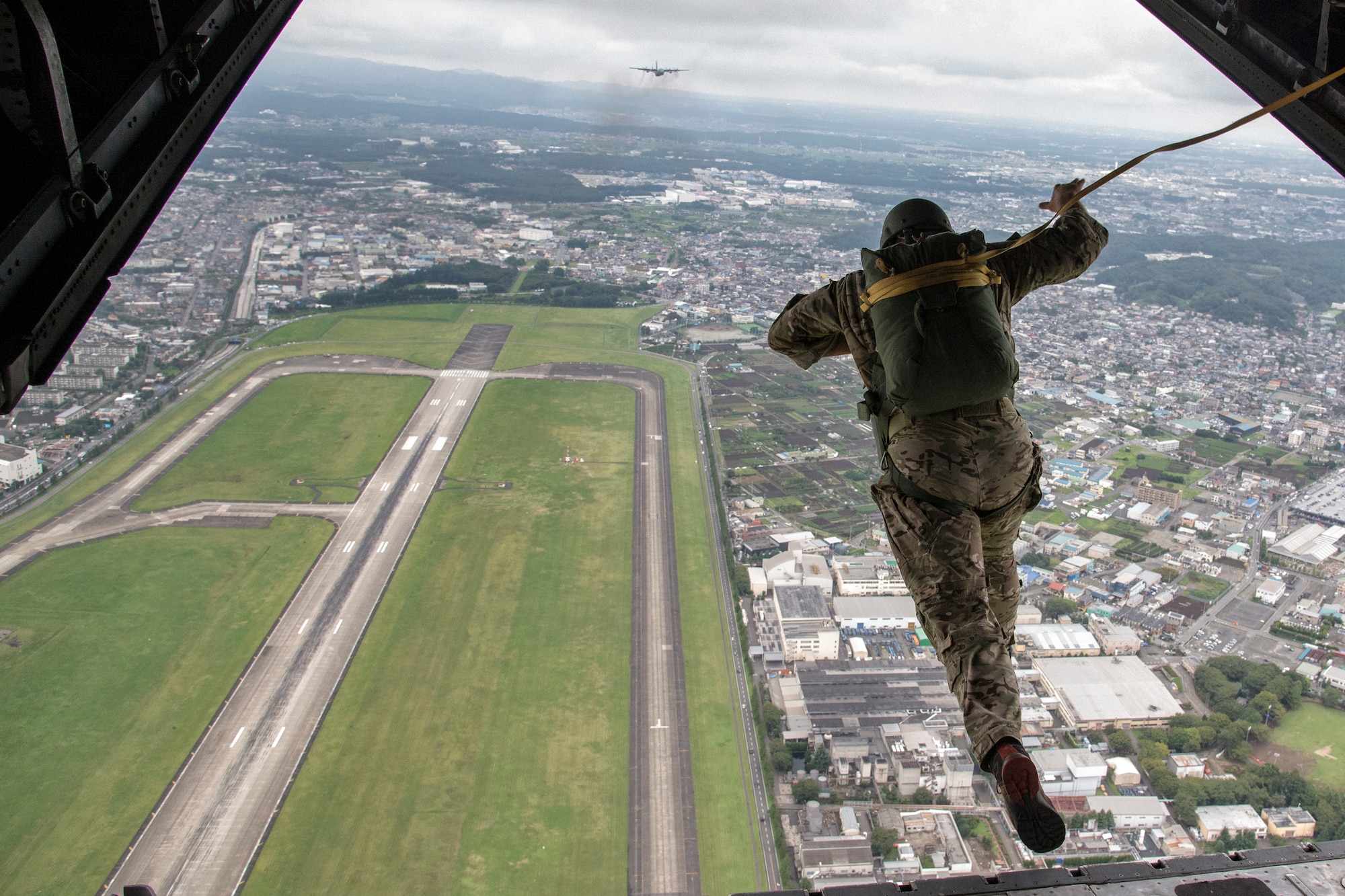 U.S. Soldiers with the 1st Battalion, 1st Special Forces Group (Airborne) conduct an airdrop jump demonstration from a C-130 Hercules over Yokota Air Base, Japan, during the Japanese-American Friendship Festival Sept. 7, 2014. Yokota welcomed approximately 148,000 visitors during the two-day festival. (U.S. Air Force photo by Senior Airman Michael Washburn/Released)