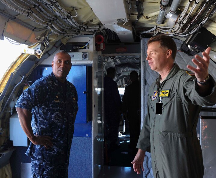 Navy Capt. Stanley Keeve, Jr., Joint Base Pearl Harbor-Hickam commander, receives a brief about the KC-135 Stratotanker from Lt. Col. Rusty Evers, 96th Air Refueling Squadron operations officer, during an immersion tour on the JBPHH flightline Sept. 4, 2014. Keeve was briefed by 15th Wing leaders and visited numerous squadrons to become familiar with the wing mission and operations. Note: This photo was edited with a black box for security purposes. (U.S. Air Force photo by 1st Lt. Andrea Dykes)