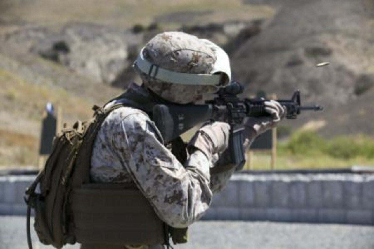 Marine Corps Cpl. Rene Gonzalez engages his target during a table three shoot at Marine Corps Base Camp Pendleton, Calif., Sept. 4, 2014. Table three is part of the Combat Marksmanship Program, which is designed to keep Marines in a combat mindset and ready for what the mission might demand. Gonzalez is a data network specialist with the 15th Marine Expeditionary Unit. U.S. Marine Corps photo by Cpl. Anna Albrecht