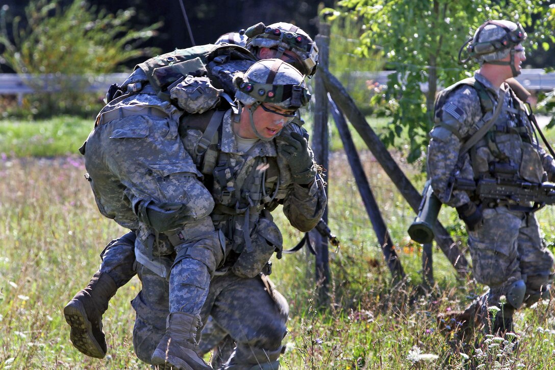 U.S. paratroopers carry a simulated wounded soldier to the medical evacuation site during Saber Junction 2014 on the Joint Multinational Readiness Center in Hohenfels, Germany, Aug. 28, 2014.