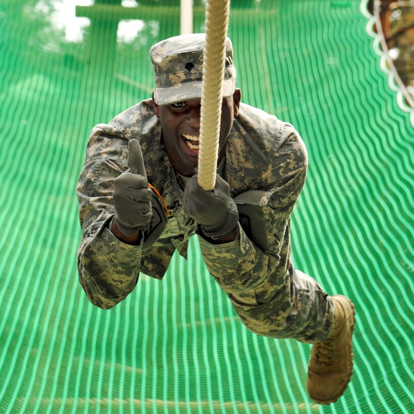 U.S. Army Spc. Elliot Graham gives the thumbs up showing his motivation while negotiating a rope obstacle at the 7th Army Joint Multinational Training Command's Grafenwoehr Training Area, Germany, Sept. 4, 2014. Graham is assigned to Headquarters Company, 18th Combat Sustainment Support Battalion.