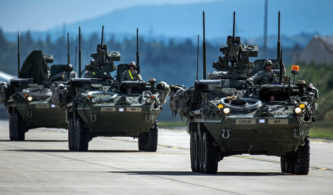 U.S. Army Stryker infantry carrier vehicles convoy across the flightline during Steadfast Javelin II, a NATO exercise, on Ramstein Air Base, Germany, Sept. 3, 2014.