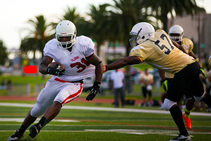 Bennie Netters, a fullback with the 1st Light Armored Reconnaissance Battalion Highlanders, ran the ball for a touchdown during a game where the Highlanders claimed a 20-14 victory over the Headquarters and Support Battalion Spartans at the Paige Fieldhouse football field here, Sept. 8.