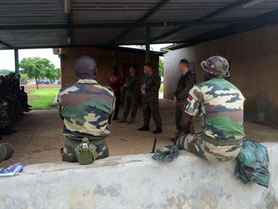 Marines and Coastguardsmen with Special-Purpose Marine Air-Ground Task Force Africa 14 discuss personal-protective equipment with Senegalese Companie de Fusilier Marine Commandos, or COFUMACO, in Toubacouta, Senegal, Aug. 25, 2014.   The theater-security cooperation team will train and advise their counterpart cadre, the Senegalese Companie de Fusilier Marine Commandos, or COFUMACO, on maritime security force assistance, marksmanship exercises, patrolling techniques and small-boat tactics and skills. (Courtesy Photo)