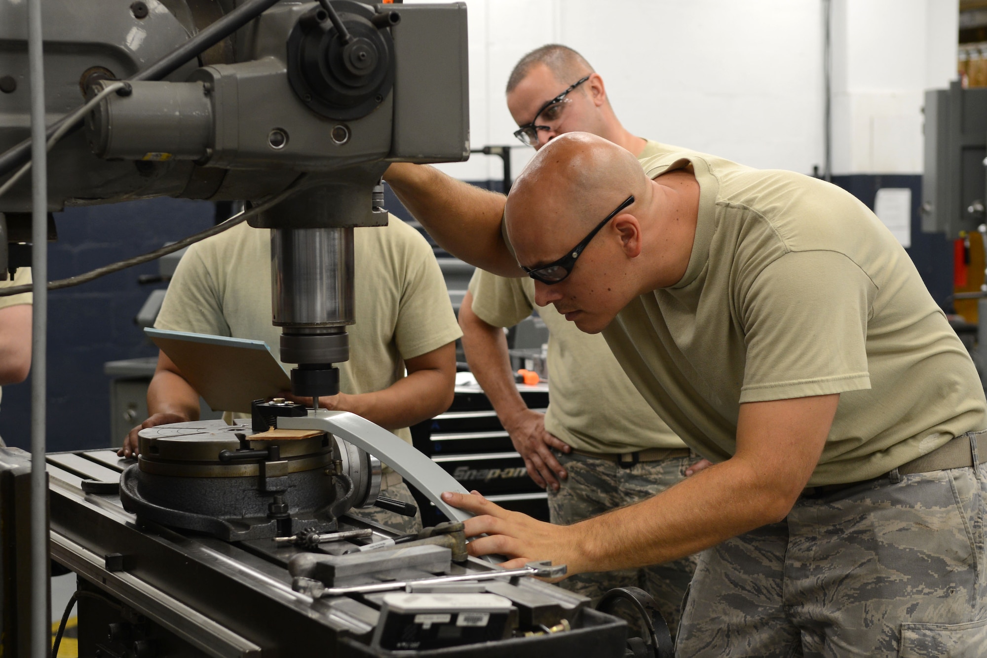 Staff Sgt. Joshua Osvold drills holes into an Improved Nose Wheel Snubber Brake Aug. 12, 2014, at MacDill Air Force Base, Fla. The KC-135 Stratotanker uses the snubber brake to eliminate noise and vibration when the landing gear is retracted. Osvold is a 6th Maintenance Group aircraft metals technologists. (U.S. Air Force photo/Airman 1st Class Tori Schultz)