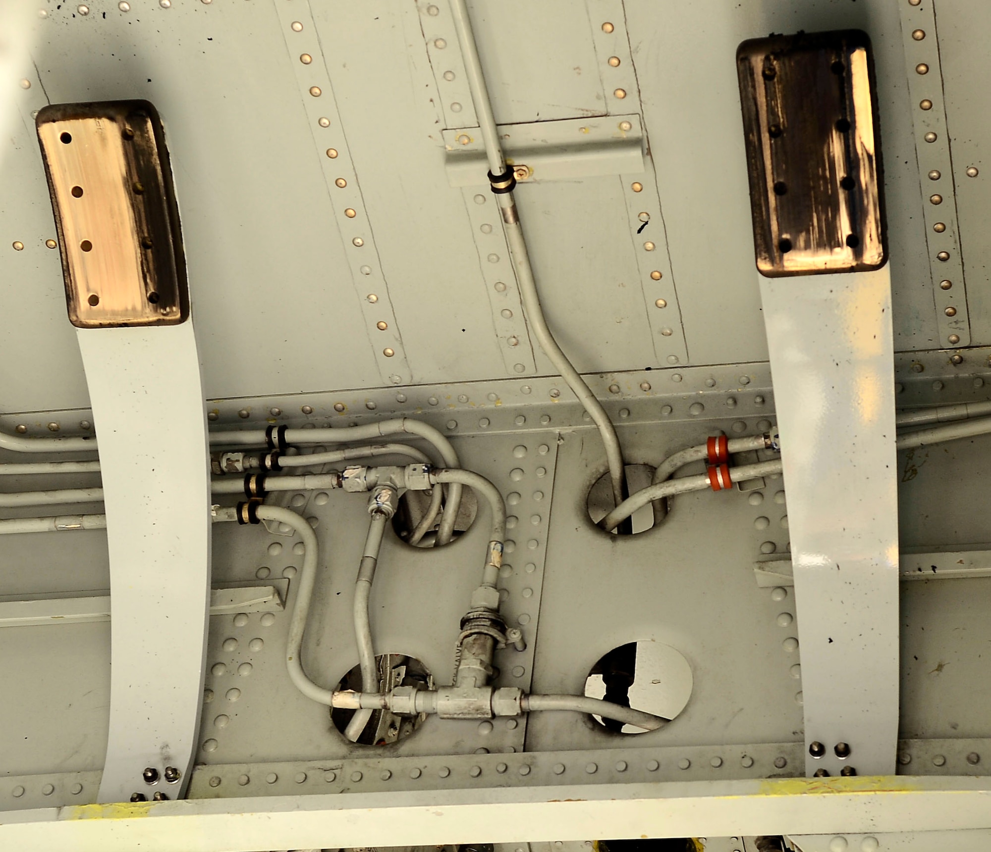 Two snubber brakes sit on a KC-135 Stratotanker Aug. 12, 2014, at MacDill Air Force Base, Fla. The snubber brake system consists of two brake linings attached to two spring arms, which contact the nose landing gear tires after gear retraction to eliminate noise and vibration. (U.S. Air Force photo/Airman 1st Class Tori Schultz)