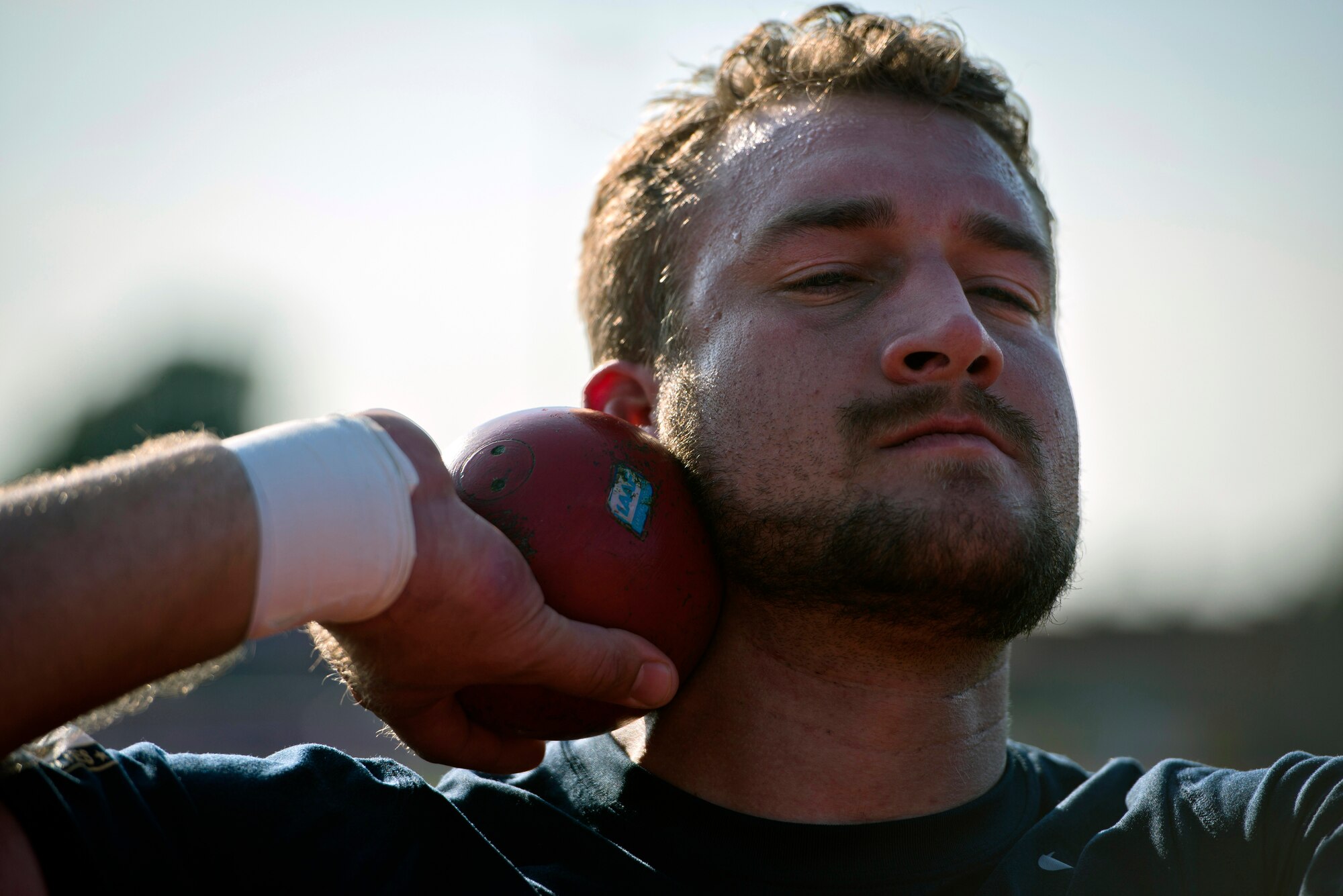 Retired Navy  Petty Officer 3rd Class Max Rohn prepares to toss a shot put during training for the inaugural 2014 Invictus Games Sept. 8, 2014, at Mayesbrook Field in London. The international paralympic-style, multi-sport event is designed for wounded service members. (U.S. Air Force photo/Staff Sgt. Andrew Lee)