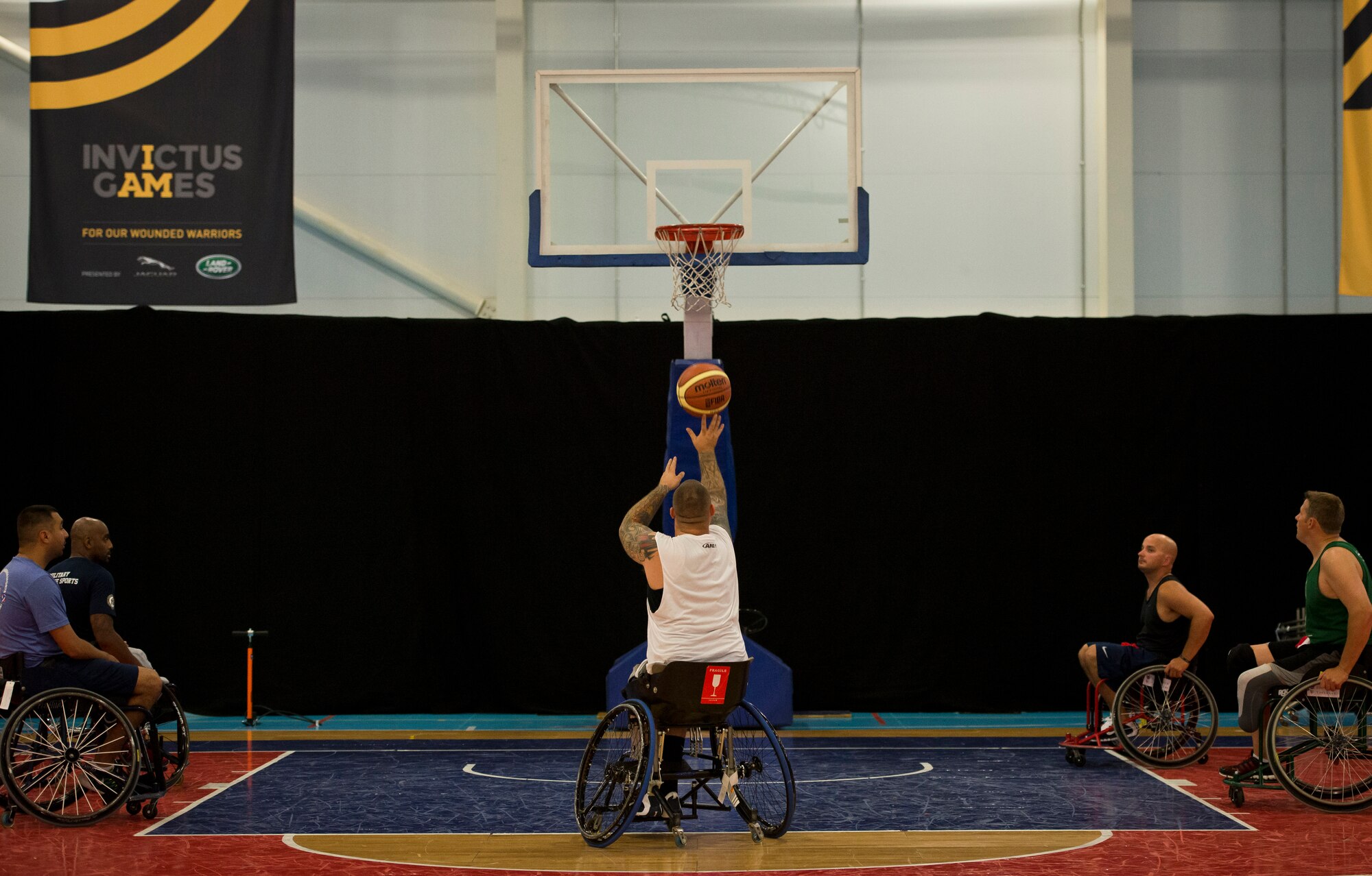 Steven Davis, a retired U.S. Navy Airman, shoots a free-throw during wheelchair basketball practice at Mayesbrook Field Sport House Sept. 8, 2014, in London. Davis is a member of the United States' wheelchair basketball team for the inaugural 2014 Invictus Games. (U.S. Air Force photo/Staff Sgt. Andrew Lee)