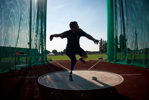 Max Rohn, a retired U.S. Navy Petty Officer 3rd Class, winds up to throw a discus during training for the inaugural 2014 Invictus Games at Mayesbrook Field Sept. 8, 2014, in London. The Invictus Games is an international Paralympic-style, multi-sport event designed for wounded service members. (U.S. Air Force photo/Staff Sgt. Andrew Lee)
