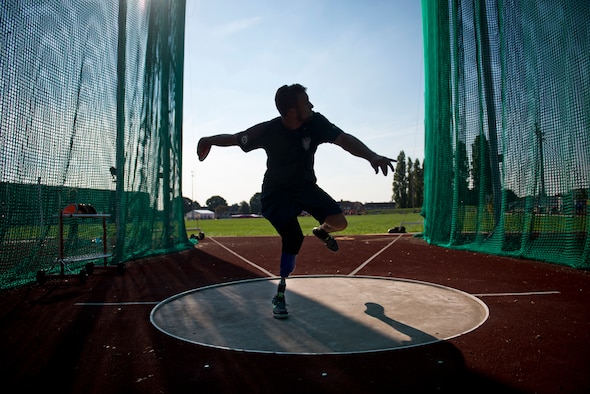Max Rohn, a retired U.S. Navy Petty Officer 3rd Class, winds up to throw a discus during training for the inaugural 2014 Invictus Games at Mayesbrook Field Sept. 8, 2014, in London. The Invictus Games is an international Paralympic-style, multi-sport event designed for wounded service members. (U.S. Air Force photo/Staff Sgt. Andrew Lee)