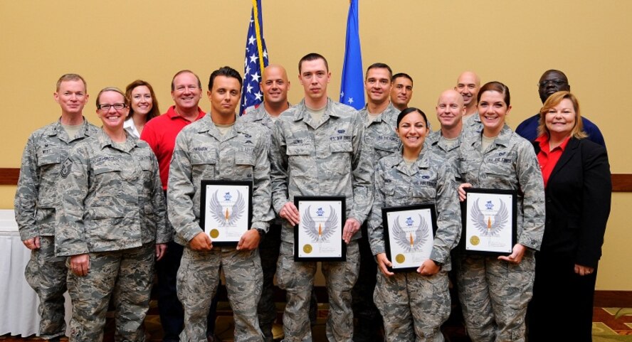 The September 2014 Diamond Sharp Award winners pose for a group photo with their First Sergeants, 1st Special Operations Wing leadership and local community sponsors at the Sound Side Club, Hurlburt Field, Fla., Sept. 5, 2014. (U.S. Air Force photo/Airman 1st Class Andrea Posey)