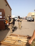 Pararescuemen with the 212th Rescue Squadron, Alaska Air National Guard, don self-contained breathing apparatus and prepare to enter a building during a training exercise in Djibouti, Aug. 13. Members of the Alaska Air National Guard deployed to the Horn of Africa in support of Operation Enduring Freedom as part of Joint Task Force–Horn of Africa, attached to the 82nd Expeditionary Rescue Squadron. 