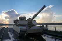 An M1A1 Abrams tank sits on an M17 floating raft, which is used to carry vehicles and troops over small bodies of water, during a training exercise conducted by Bridge Company, 8th Engineer Support Battalion, 2nd Marine Logistics Group, on the morning of Sept. 4, 2014, aboard Marine Corps Base Camp Lejeune, N.C. The raft was towed and guided by two Mach 3 Bridge Erection Boats, carrying approximately 140 tons across New River. (U.S. Marine Corps photo taken by Lance Cpl. Alex W. Mitchell/released)