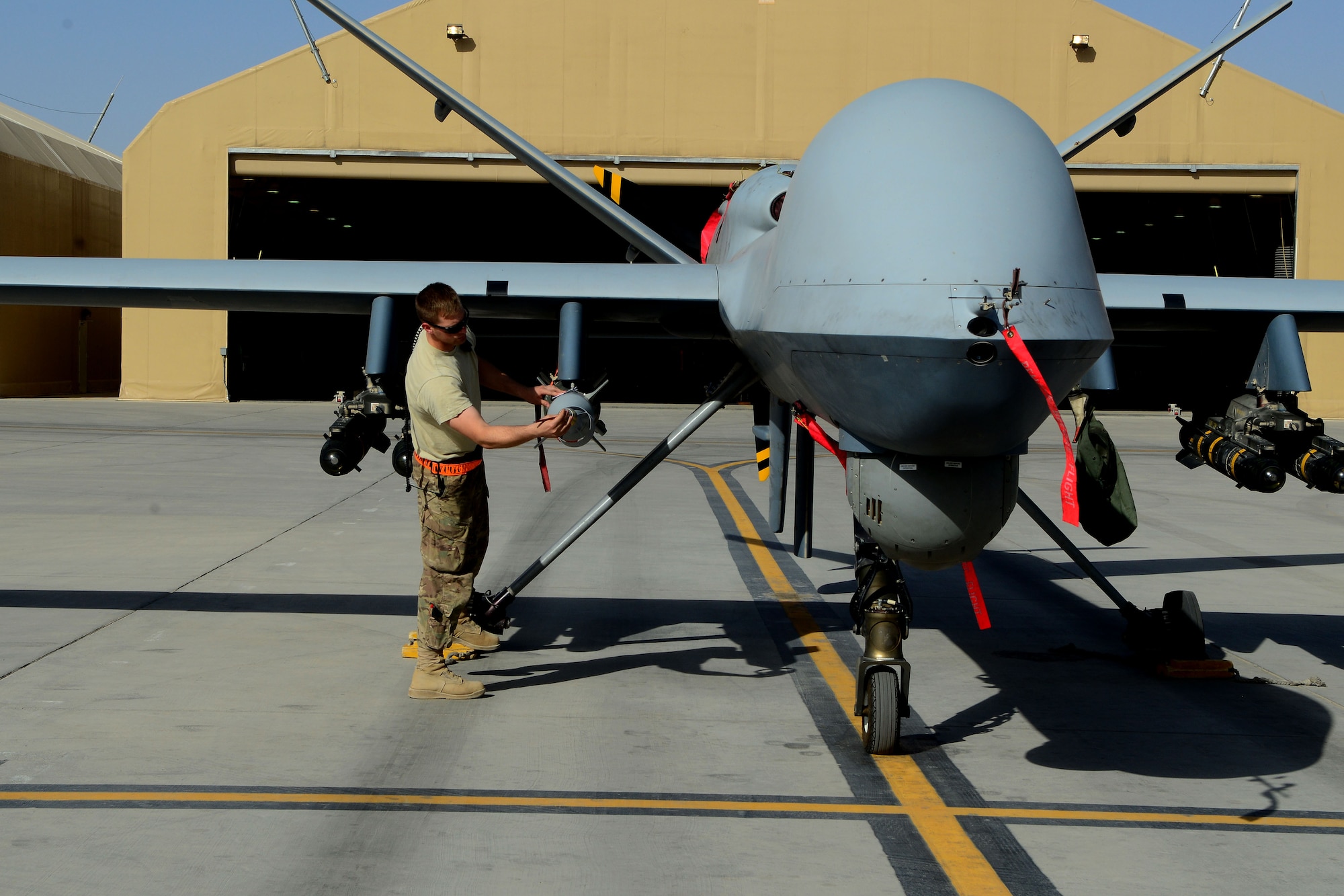Staff Sgt. Nelson Cherry inspects an MQ-9 Reaper with the 62nd Expeditionary Reconnaissance Squadron Aug. 18, 2014, at Kandahar Airfield, Afghanistan. The Reaper is launched, recovered and maintained here. It is also remotely operated by pilots in bases located in the U.S. Cherry is an aircraft armament systems specialist with the 451st Expeditionary Aircraft Maintenance Squadron. (U.S. Air Force photo/Staff Sgt. Evelyn Chavez)