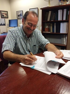 Bob Desista, acting chief, Regulatory/Permitting Division, U.S. Army Corps of Engineers, New England District, signs the permits for the Block Island Wind Farm and Block Island Transmission System.