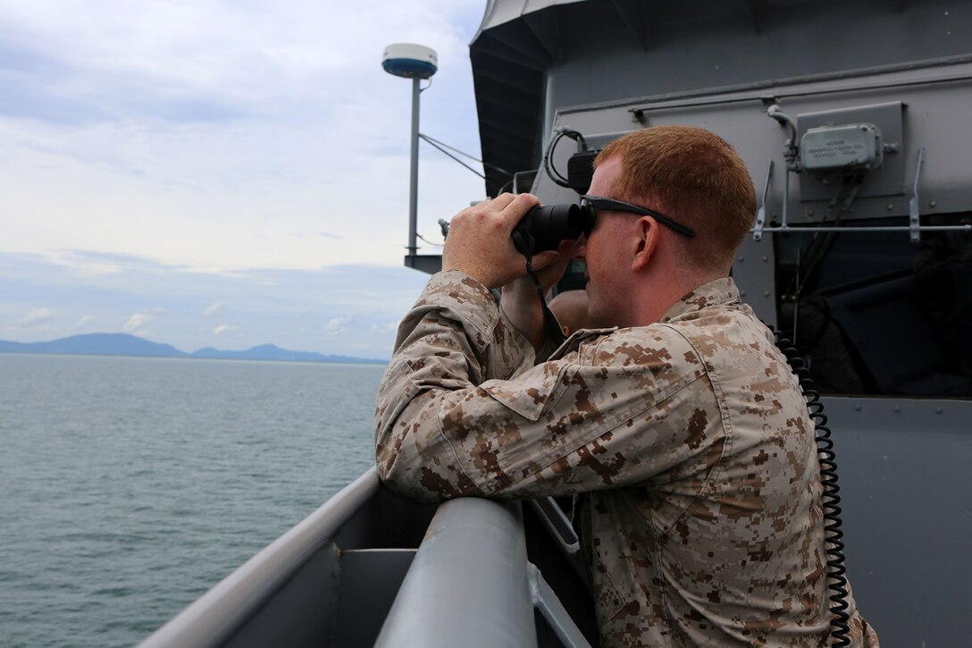 1st Lt. James Lynch, a platoon commander with Echo Company, Battalion Landing Team 2nd Battalion, 1st Marines, 11th Marine Expeditionary Unit, a member of the USS Comstock’s small craft action team, and a Boxford, Massachusetts  native, observes surface activity while the ship conducts a straits transits   during their deployment Sept. 6. The 11th MEU and Makin Island Amphibious Ready Group are deployed to the U.S. 7th Fleet area of operations as a sea-based, expeditionary crisis response force capable of conducting amphibious missions across the full range of military operations. (U.S. Marine Corps photo by Sgt. Melissa Wenger/Released) 