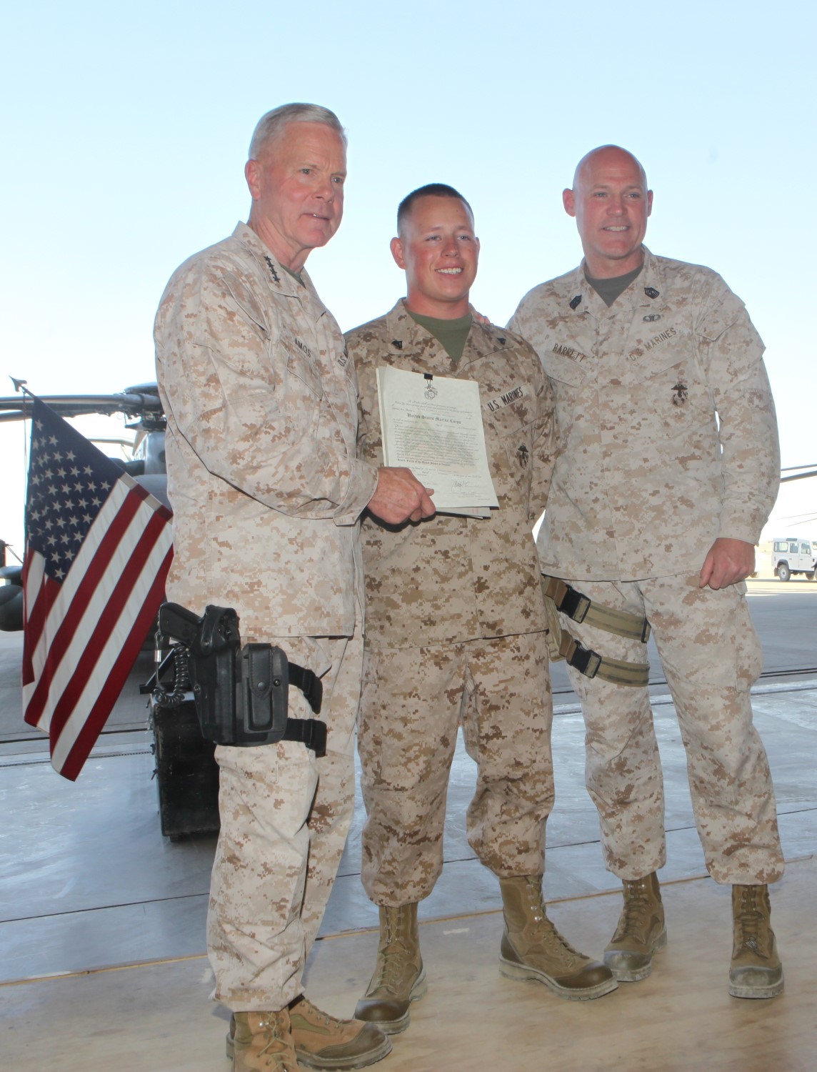 Corporal Matthew Padilla, center, an airframe mechanic with Marine Aviation Logistics Squadron 70, Marine Aircraft Group - Afghanistan, gets his photo taken with Gen. James F. Amos, right, the 35th Commandant of the Marine Corps, and Sgt. Maj. Micheal Barrett, the 17th Sergeant Major of the Marine Corps, following his meritorious promotion ceremony aboard Camp Bastion, Afghanistan, Sept. 6, 2014. Gen. Amos meritoriously promoted Padilla, a native of Littleton, Colo., to the rank of corporal during his final visit to Helmand province.