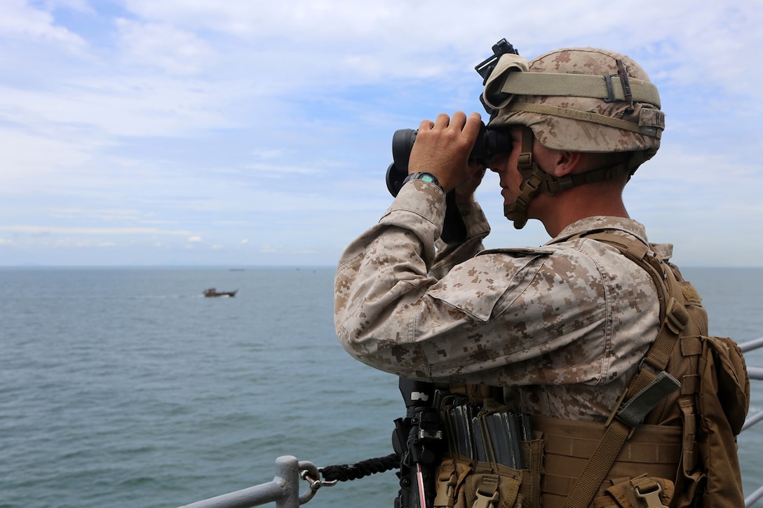 Lance Cpl. Austin Hansen, a rifleman with Echo Company, Battalion Landing Team 2nd Battalion, 1st Marine Regiment, 11th Marine Expeditionary Unit, a member of the USS Comstock’s small craft action team, and a Sedrow-Woolley, Washington native, observes surface activity while the ship conducts a straits transits during their deployment Sept. 6. The 11th MEU and Makin Island Amphibious Ready Group are deployed to the U.S. 7th Fleet area of operations as a sea-based, expeditionary crisis response force capable of conducting amphibious missions across the full range of military operations. (U.S. Marine Corps photo by Sgt. Melissa Wenger/Released) 