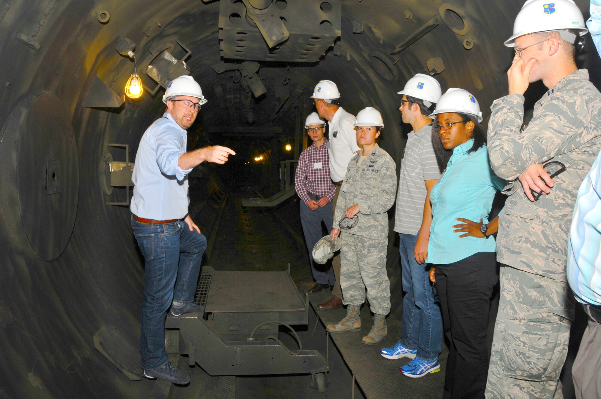 Members of the Air Force Research Laboratory (AFRL) Junior Force Council pictured here listen to Marshall Polk (far left), an engineer with the AEDC Space and Missiles Sustainment Branch, during a tour on Aug. 29. Polk describes the function of the Hypervelocity Ballistic Range G test facility while viewing one of the impact tanks. AFRL, in partnership with AEDC, recently established a new hypersonic research branch at AEDC known as the High Speed Experimentation Branch. (Photo by Jacqueline Cowan)