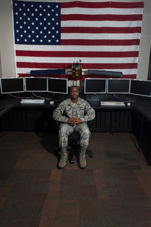 Senior Airman Trey Barnes, 2nd Space Operations Squadron space systems operator, sits in front of a model of a Block IIF GPS-satellite in the Master Control Station on Schriever Air Force Base, Colo., Sept. 4, 2014. Barnes maintains contact with more than 30 satellites to ensure the overall accuracy of the GPS signal for the more than 3 billion users around the world. (U.S. Air Force photo/Airman 1st Class Krystal Ardrey)