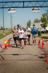 Airmen from the 91st Missile Wing finish the final leg of the Red Button Run on Minot Air Force Base, N.D., Sept. 5, 2014. The race covered the entire 8,500 square-foot missile complex, hitting all 15 Missile Alert Facilities, and running through several surrounding towns. It ended at Minot Air Force Base's main gate. The runners consist of 39 teams of four people, each running 10-mile legs. (U.S. Air Force photo/Airman 1st Class Apryl Hall)