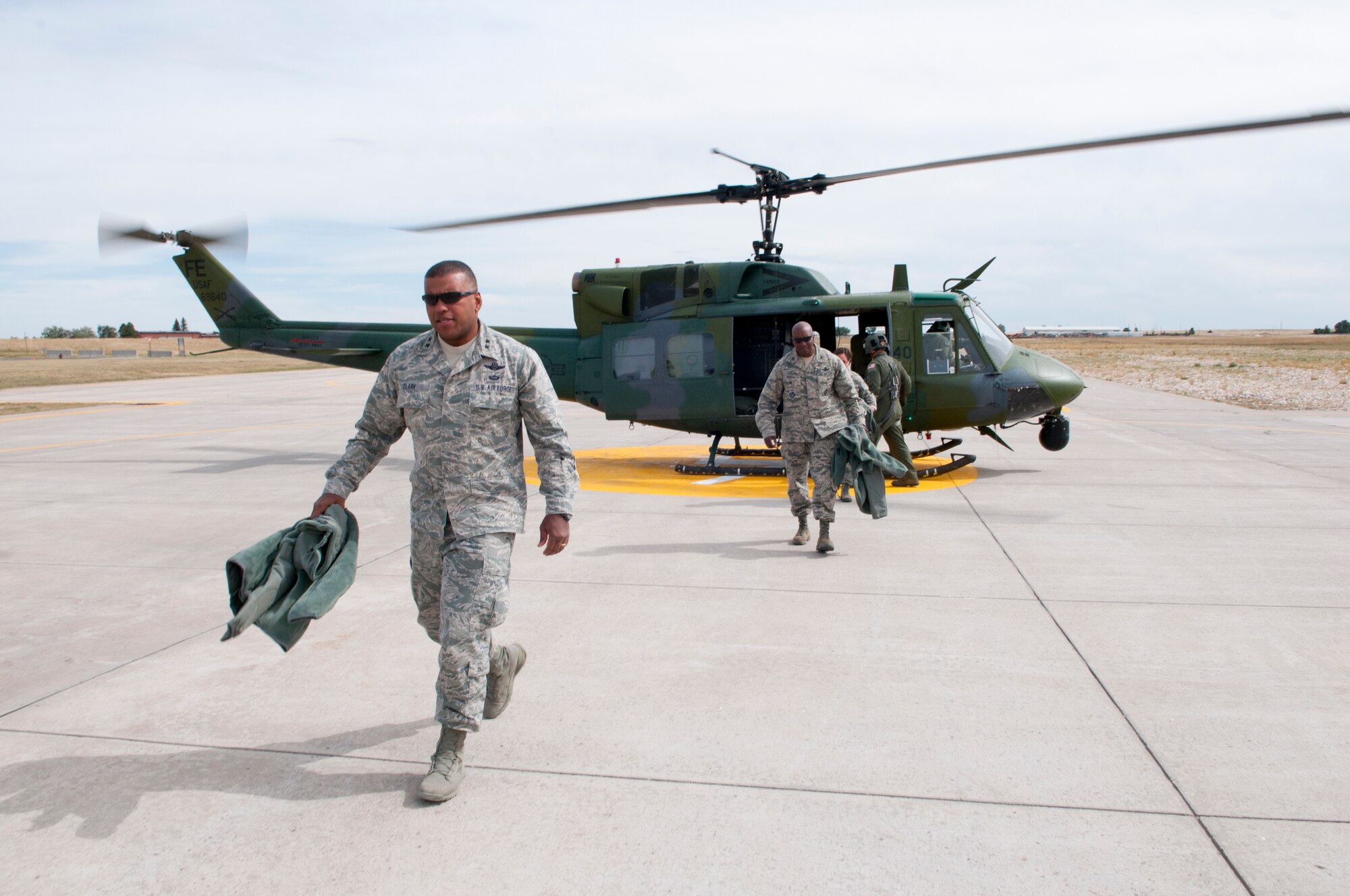Maj. Gen. Richard Clark, Air Force Global Strike Command vice commander, exits a UH-1N helicopter arriving on F.E. Warren Air Force Base, Wyo., Sept. 4 2014. Clark was returning from a trip to Camp Guernsey, Wyo., where he familiarized himself with the training capabilities of the 620th Ground Combat Training Squadron. (U.S. Air Force photo by Lan Kim)