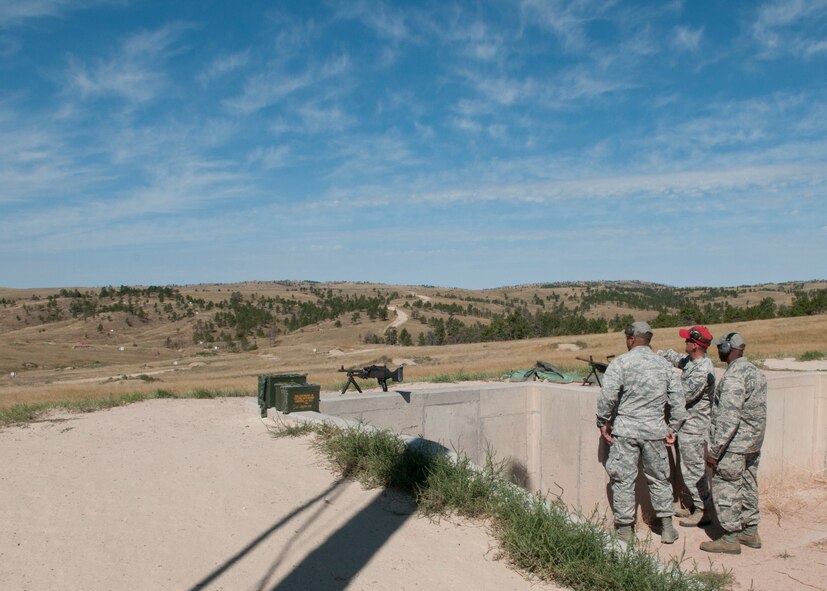 Staff Sgt. Brandon Layton, a 620th Ground Combat Training Squadron combat arms instructor, briefs Maj. Gen. Richard Clark, Air Force Global Strike Command vice commander, and Col. Carl Jones, 90th Missile Wing vice commander, on the target distances of a long distance range at Camp Guernsey, Wyo., Sept. 4, 2014. Clark visited the camp to become familiarized with the training capabilities offered at Camp Guernsey. (U.S. Air Force photo by Lan Kim)