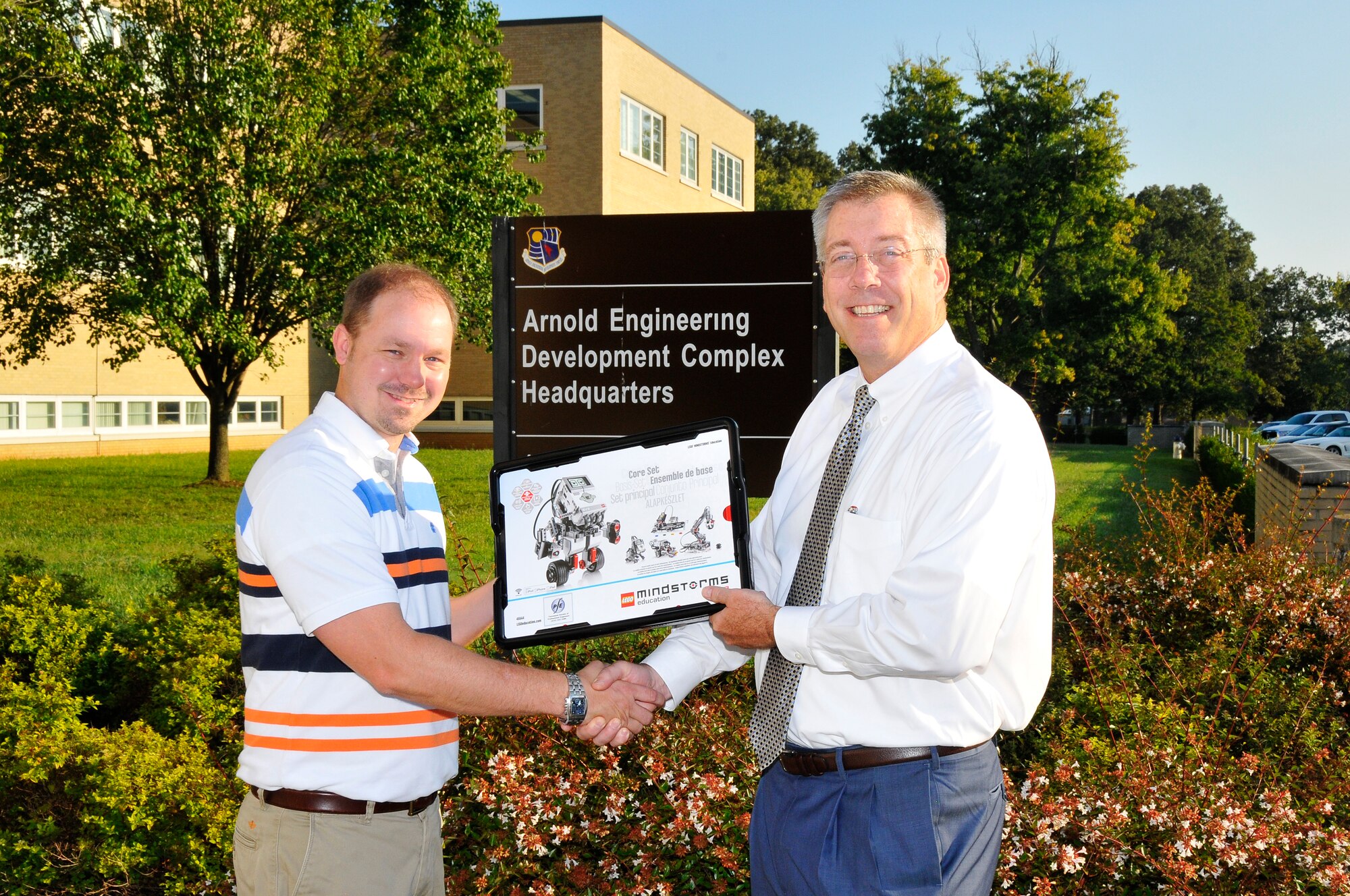 The ATA Employee and Community Activities Committee recently made a $3,300 donation to the Tullahoma Chapter of the Tennessee Society of Professional Engineers (TSPE), benefitting the local FIRST® LEGO® League (FLL) teams. Pictured at left is John McInturff, past president of the TSPE’s Tullahoma Chapter, accepting one of the robot kits for the FLL teams from Jeff Haars, ATA deputy general manager. (Photo by Rick Goodfriend)