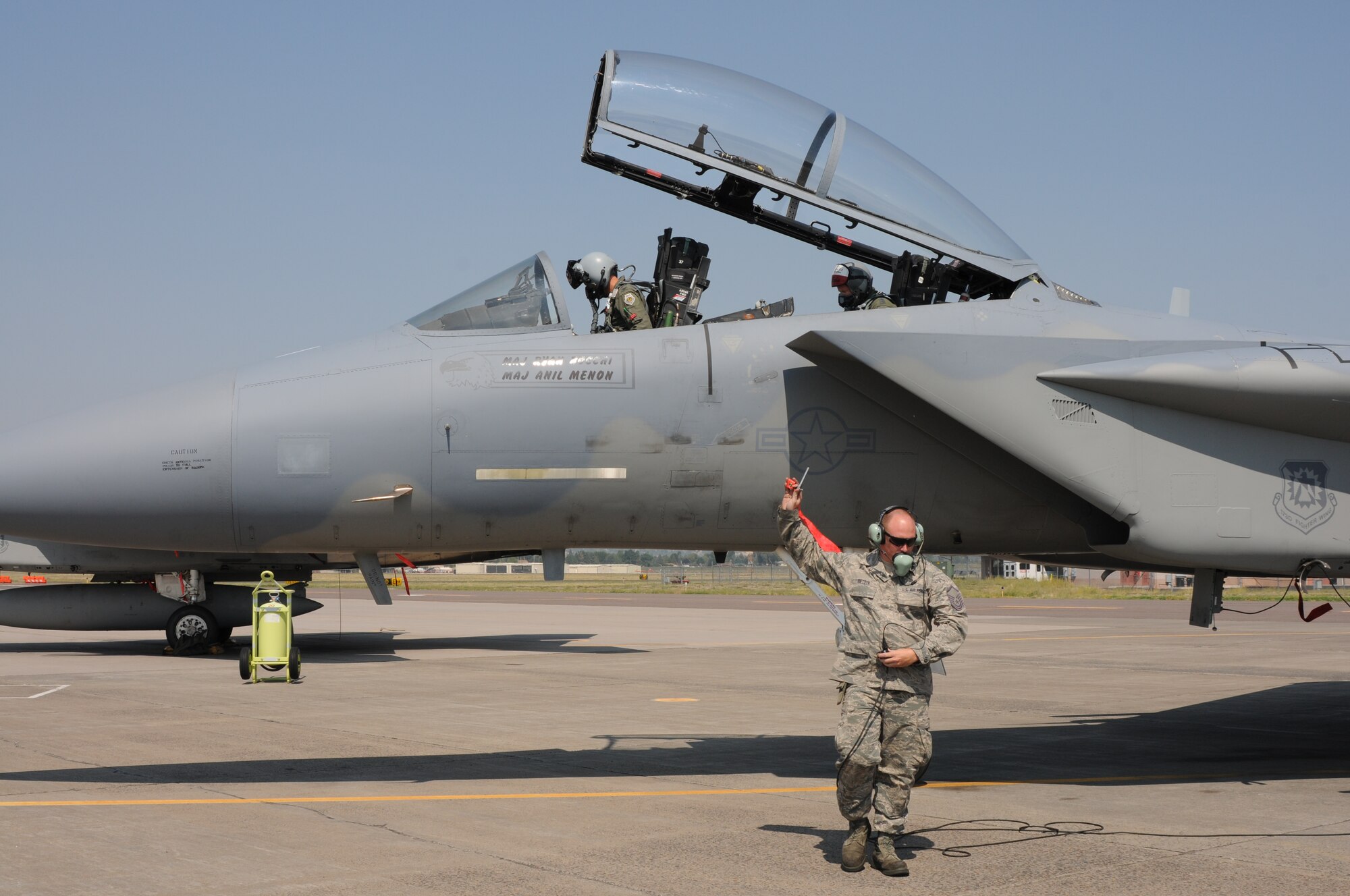 Master Sgt. Casey Rietdyk, 173rd Fighter Wing F-15 crew chief, signals to Col. Wes French (front seat), 173rd Operations Group commander, and Gen. Robin Rand, commander of Air Education and Training Command, that he pulled a pin in preparation for their flight at Kingsley Field, Klamath Falls, Ore., Aug. 27. As the sole U.S. Air Force F-15C training base, the 173 FW is aligned under AETC. (U.S. Air National Guard photo by Master Sgt. Jennifer Shirar)  