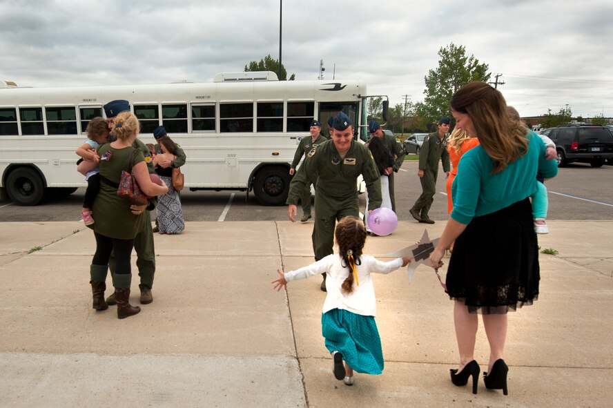 Members of the 69th Bomb Squadron return home to Minot Air Force Base, N.D., Sept. 8, 2014, from a six-month deployment to Andersen AFB, Guam. Airmen from the 69th BS and 5th Bomb Wing deployed to Andersen AFB in support of U.S. Pacific Command’s Continuous Bomber Presence. (U.S. Air Force photo/Senior Airman Brittany Y. Bateman)
