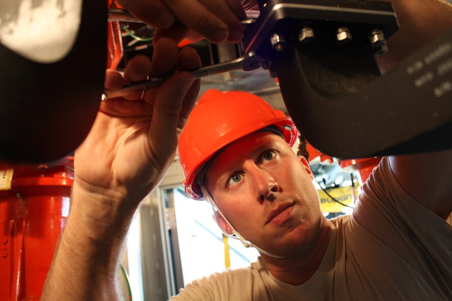 Staff Sgt. Christopher Marek, 5th Communications Squadron ground radar craftsman, removes bolts securing waveguides as he prepares to remove and replace a rotary joint, part of Minot Air Force Base’s digital airport surveillance system, Aug. 25. Ground radar is one of the two air traffic control and landing systems equipment career fields that transitioned from the communication squadron to the 5th Operations Support Squadron Sept. 2. (Official U.S. Air Force photo/Capt. Jeff M. Nagan)