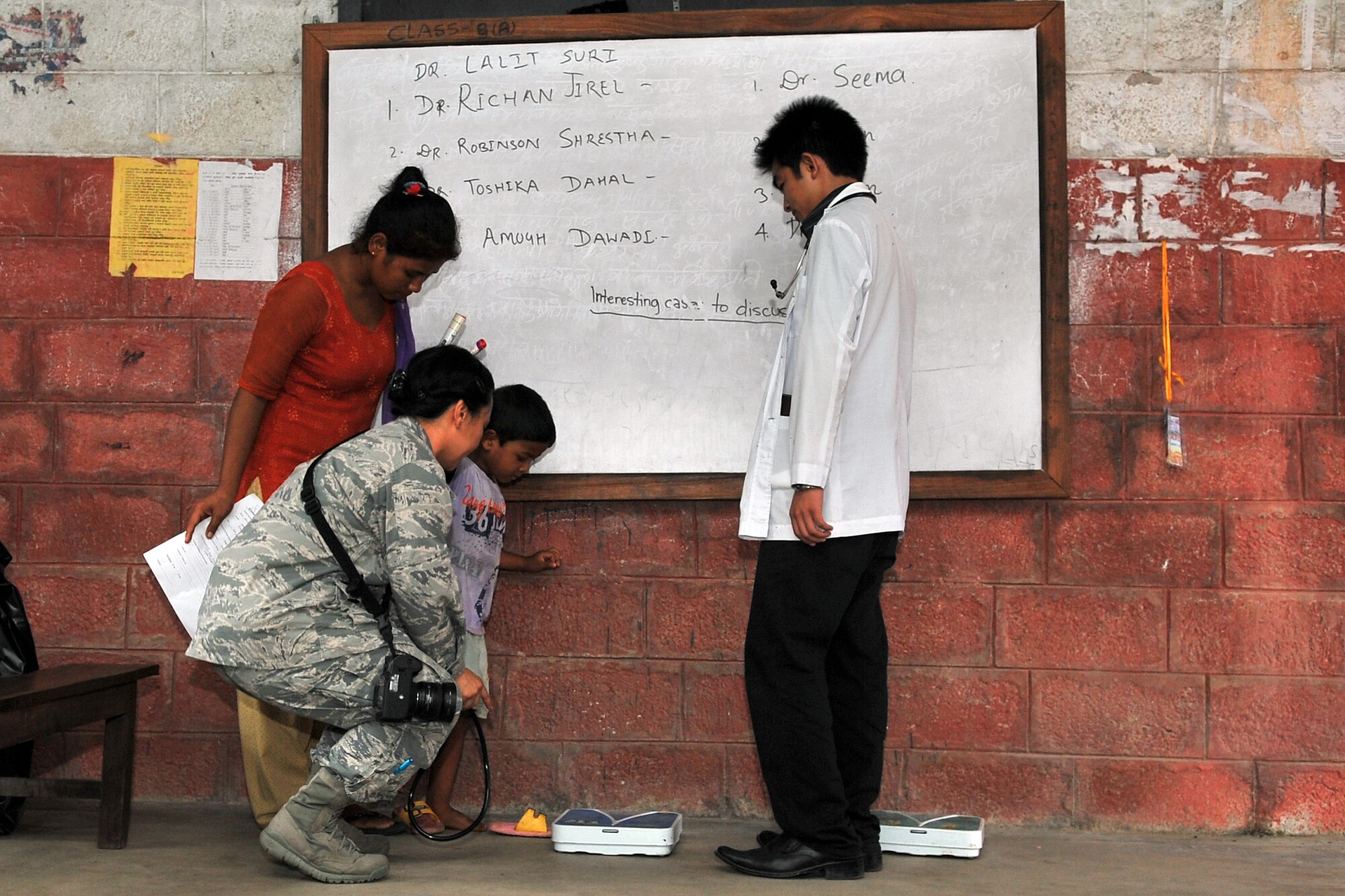 U.S. Air Force Capt. (Dr.) Enrilyn Thronson, Operation Pacific Angel-Nepal pediatrician, weighs a patient at a health services outreach site in Manahari, Nepal, Sept. 9, 2014. PACANGEL supports U.S. Pacific Command’s capacity-building efforts by partnering with other governments, non-governmental agencies and multilateral militaries in the respective region to provide medical, dental, optometry and engineering assistance to their citizens. (U.S. Air Force photo by Staff Sgt. Melissa B. White/Released)