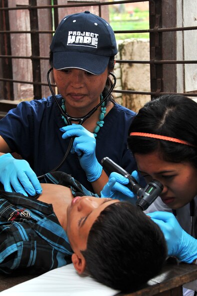 Dr. Lingie Chiu, Project Hope pediatrician, and Aanchal Shrestha, a local general medicine intern, examine a patient at a health services outreach site in Manahari, Nepal, Sept. 9, 2014, as part of Operation Pacific Angel-Nepal. PACANGEL supports U.S. Pacific Command’s capacity-building efforts by partnering with other governments, non-governmental agencies and multilateral militaries in the respective region to provide medical, dental, optometry and engineering assistance to their citizens. (U.S. Air Force photo by Staff Sgt. Melissa B. White/Released) 
