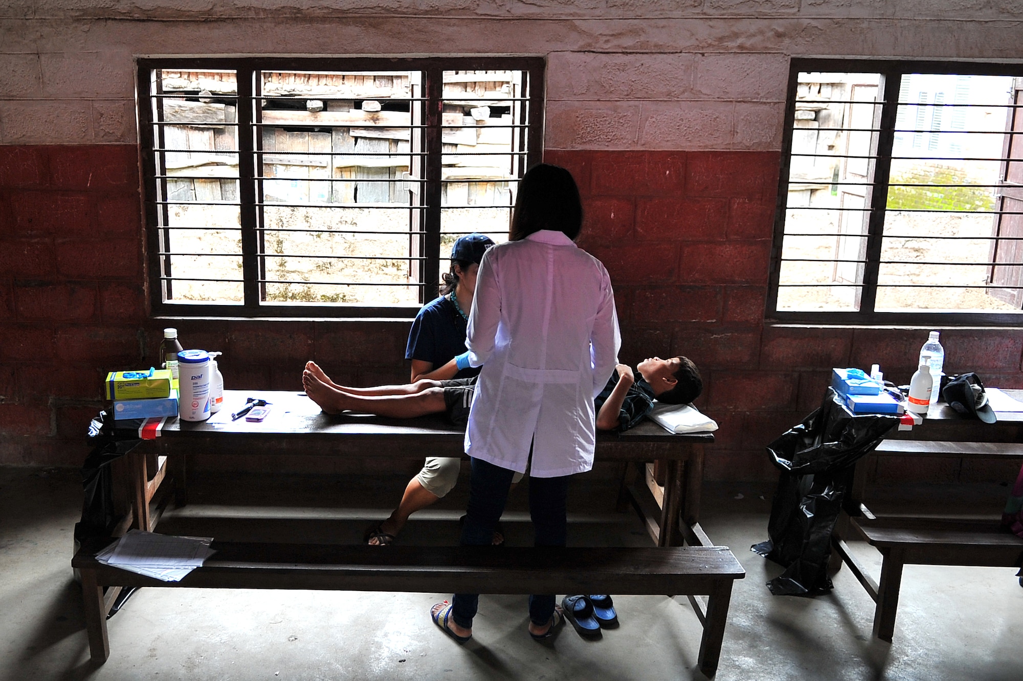 Dr. Lingie Chiu, Project Hope pediatrician, and Aanchal Shrestha, a local general medicine intern, examine a patient at a health services outreach location in Manahari, Nepal, Sept. 9, 2014, as part of Operation Pacific Angel-Nepal. PACANGEL helps cultivate common bonds and foster goodwill between the U.S., Nepal and regional nations by conducting multilateral humanitarian assistance and civil military operations. (U.S. Air Force photo by Staff Sgt. Melissa B. White/Released)
