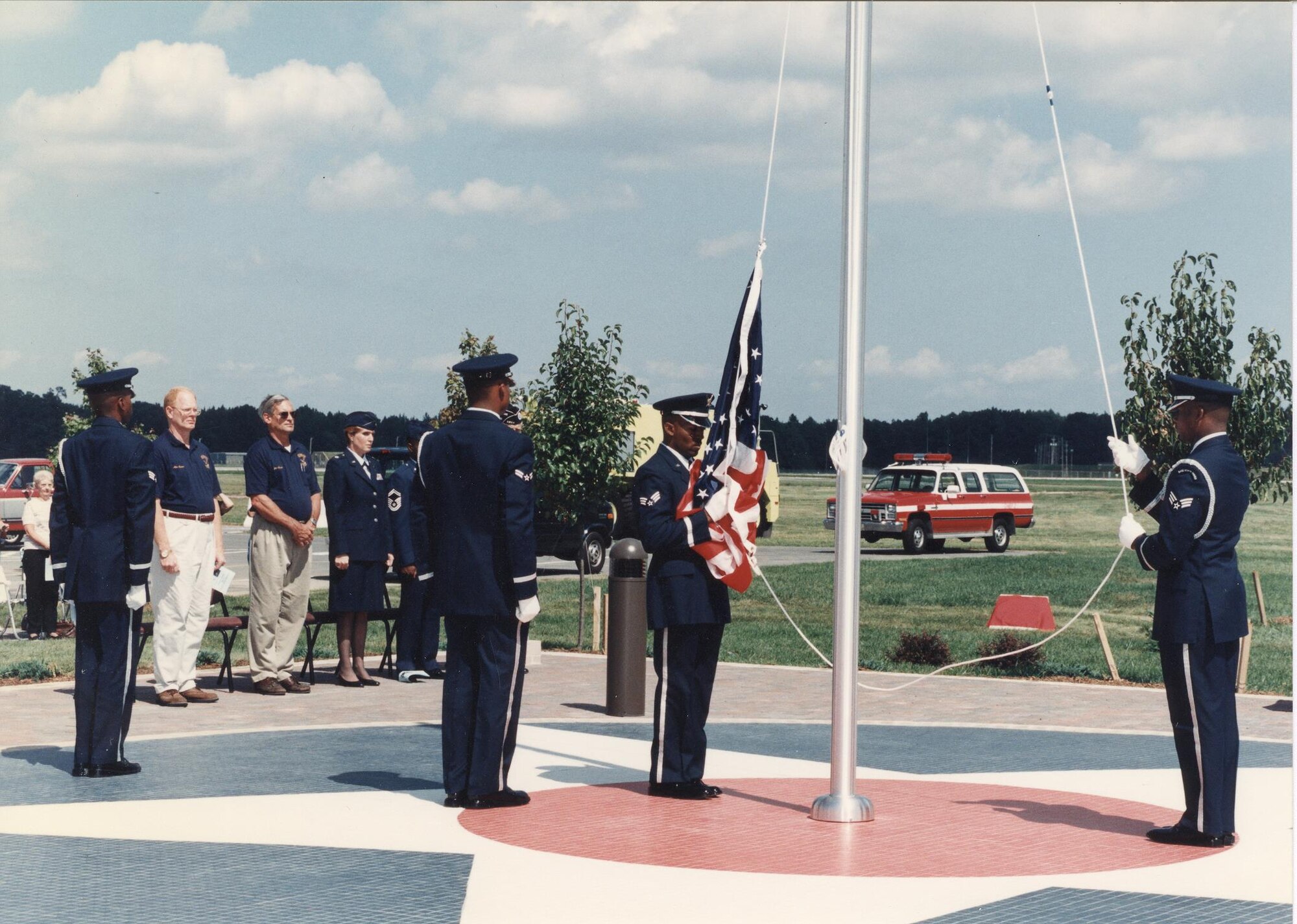 Honor Guard members raise an American flag during the dedication ceremony of the Commemoration Park Sept. 13, 1997, outside of the Air Mobility Command Museum on Dover Air Force Base, Del. Seventeen years later, this park has expanded to include additional monuments and memorials. (Courtesy photo/ Harry Heist) 