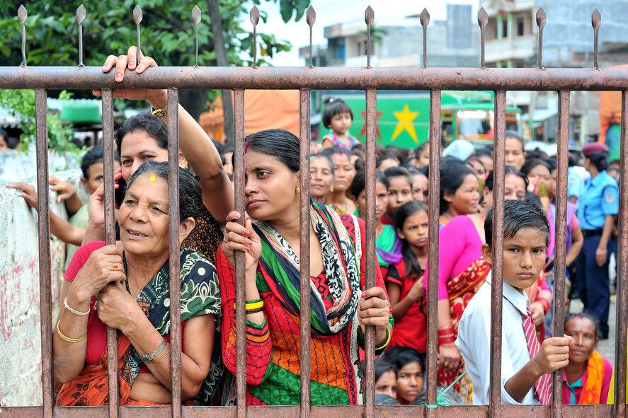 Nepalese women and children wait outside the gate to be seen by Operation Pacific Angel-Nepal at a health services outreach site in Manahari, Nepal, Sept. 9, 2014. PACANGEL supports U.S. Pacific Command’s capacity-building efforts by partnering with other governments, non-governmental agencies and multilateral militaries in the respective region to provide medical, dental, optometry and engineering assistance to their citizens. (U.S. Air Force photo by Staff Sgt. Melissa B. White/Released)