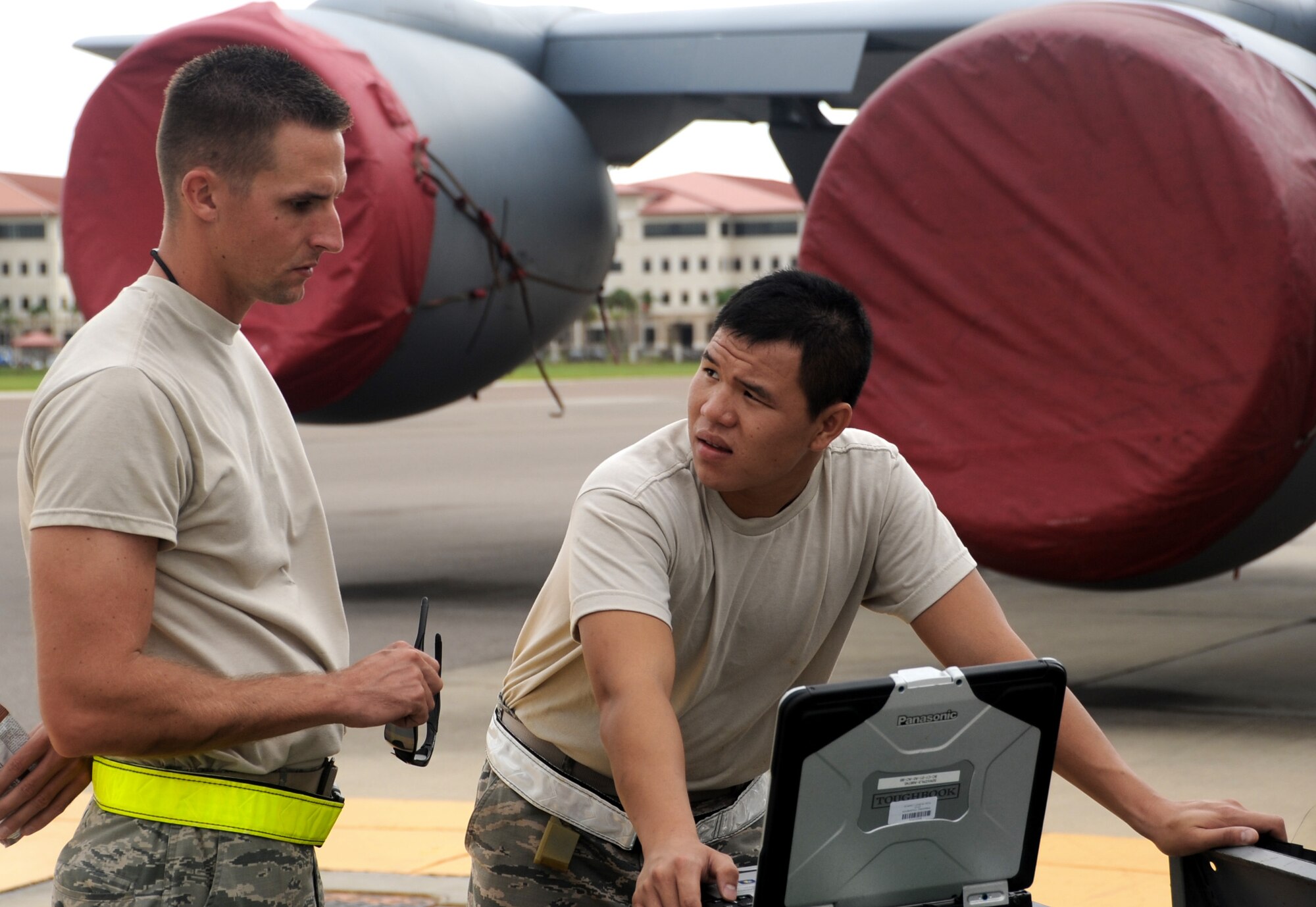 TSgt Anthony Abney explains the process of servicing the KC-135 Stratotanker's oxygen system to Amn Tung Tran Sept. 6 at MacDill AFB. The oxygen system provides oxygen to flightcrew and patients on board, in the event of an emergency.(U.S. Air Force Photo / Adam C. Borgman)