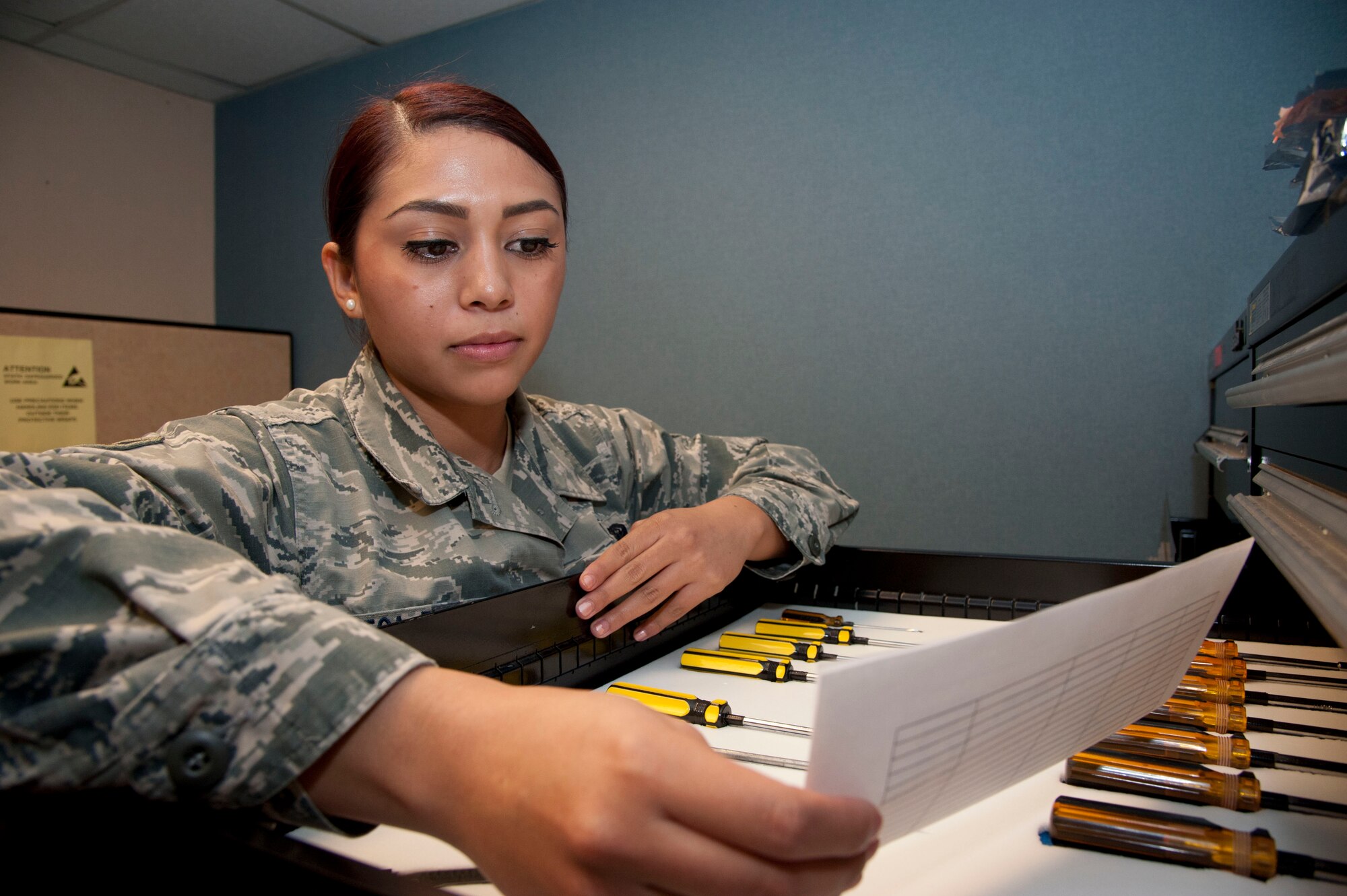 Senior Airman Yenia Ortega-Flores, a 71st Communications Flight knowledge operations manager, reads a computer work order Sept. 5. On Sept. 1 the 71st Communications Squadron became a flight. (U.S. Air Force photo/Senior Airman Frank Casciotta)