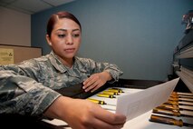 Senior Airman Yenia Ortega-Flores, a 71st Communications Flight knowledge operations manager, reads a computer work order Sept. 5. On Sept. 1 the 71st Communications Squadron became a flight. (U.S. Air Force photo/Senior Airman Frank Casciotta)