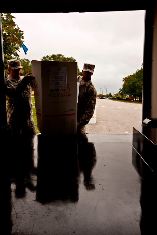 Tech. Sgt. Will Underhill, 89th Airlift Wing, and Airman Jabari Wright, 11th Logistics Readiness Squadron, load a large box of food on an 11th LRS “bread truck” near the 89th AW headquarters building, Joint Base Andrews, Md., Sept. 9, 2014. The box was one of 17 collected by 89th AW members and JBA Commissary patrons, and was collected to support the U.S. Department of Agriculture’s Feds Feed Families campaign, which all Federal agencies, including Field components, can participate in. (U.S. Air Force photo by Master Sgt. Kevin Wallace/RELEASED)