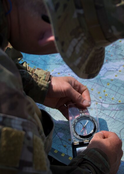 Major James Francis, Air Force Special Operations Air Warfare Center, finds coordinates on a grid map during a culmination exercise on the Eglin Air Force Base range, Aug. 27.  Duke Field’s reserve combat aviation advisors joined their active-duty counterparts for a five-day exercise of specialized spin-up training.  The Airmen move on to the Joint Readiness Training Center at Fort Polk, La., for further development. (U.S. Air Force photo/Tech. Sgt. Jasmin Taylor)