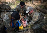 Combat aviation advisors stabilize a victim during a culmination exercise on the Eglin Air Force Base range, Aug. 27.  Duke Field’s reserve combat aviation advisors joined their active-duty counterparts for a five-day exercise of specialized spin-up training.  The Airmen move on to the Joint Readiness Training Center at Fort Polk, La., for further development. (U.S. Air Force photo/Tech. Sgt. Jasmin Taylor)