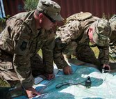 Combat aviation advisors find their coordinates before a hike through the swamp on the Eglin Air Force Base range, Aug. 27.  Duke Field’s reserve combat aviation advisors joined their active-duty counterparts for a five-day exercise of specialized spin-up training.  The Airmen move on to the Joint Readiness Training Center at Fort Polk, La., for further development. (U.S. Air Force photo/Tech. Sgt. Jasmin Taylor)