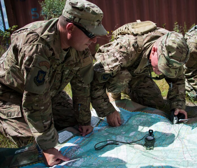 Combat aviation advisors find their coordinates before a hike through the swamp on the Eglin Air Force Base range, Aug. 27.  Duke Field’s reserve combat aviation advisors joined their active-duty counterparts for a five-day exercise of specialized spin-up training.  The Airmen move on to the Joint Readiness Training Center at Fort Polk, La., for further development. (U.S. Air Force photo/Tech. Sgt. Jasmin Taylor)