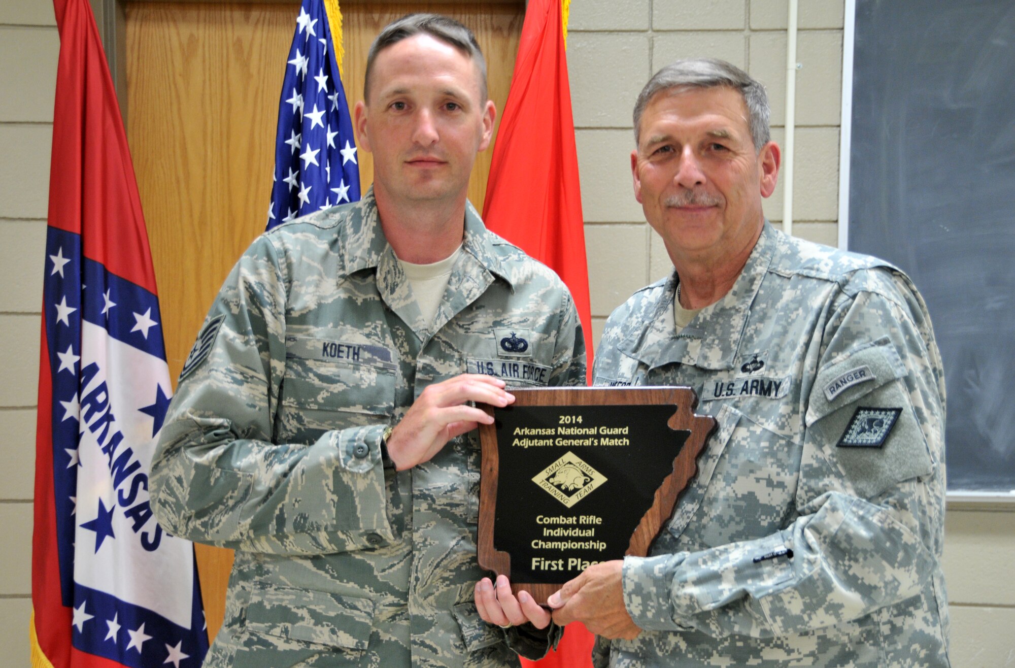 Tech Sgt. Frank Koeth, left, is presented the TAG Match's first overall Combat Rifle Individual Championship award by Maj. Gen. William Wofford, Arkansas National Guard adjutant general, at Camp Joseph T. Robinson, North Little Rock, Arkansas on July 27, 2014. (Courtesy photo)