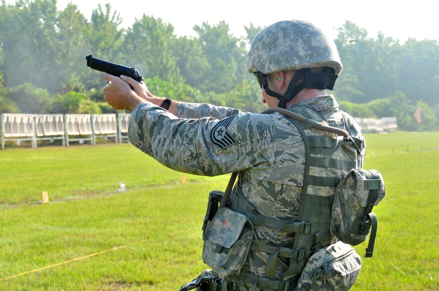 Tech. Sgt. Frank Koeth fires his pistol during the 2014 Arkansas TAG Match at Camp Joseph T. Robinson, North Little Rock, Arkansas on July 26, 2014. Koeth finished first overall in the Combat Rifle Individual Championship at the TAG Match. (Courtesy photo)