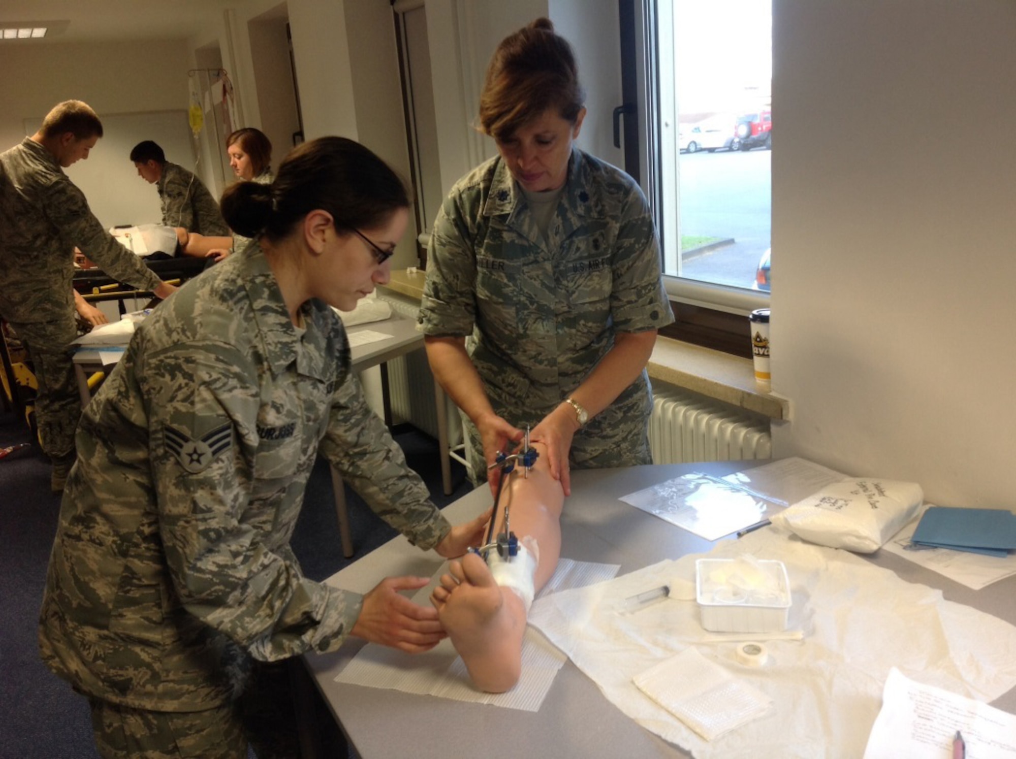 Virginia Air National Guardsman, 192nd Medical Group Airmen perform medical training procedures at Spangdahlem Air Base, Germany Medical Clinic, July 17, 2014. Spangdahlem is home to one of 11 Air Force Medical Service’s Tier One Medical “Simulation Labs” where medical team members train on “mechanical trauma dummies” known as the “medi-man”.  The dummies have the capability to talk and complain about ailments while medical team members evaluate and take the necessary steps to assist them.  Ultimately, the dummy will “crash”, providing trauma response training and fine tuning medics’ skills in a simulated environment.  The medics from the 192nd Fighter Wing supported the Spangdahlem Family Health Clinic and provided medical services during the Permanent Change of Station season this summer. (Courtesy photo/Released)