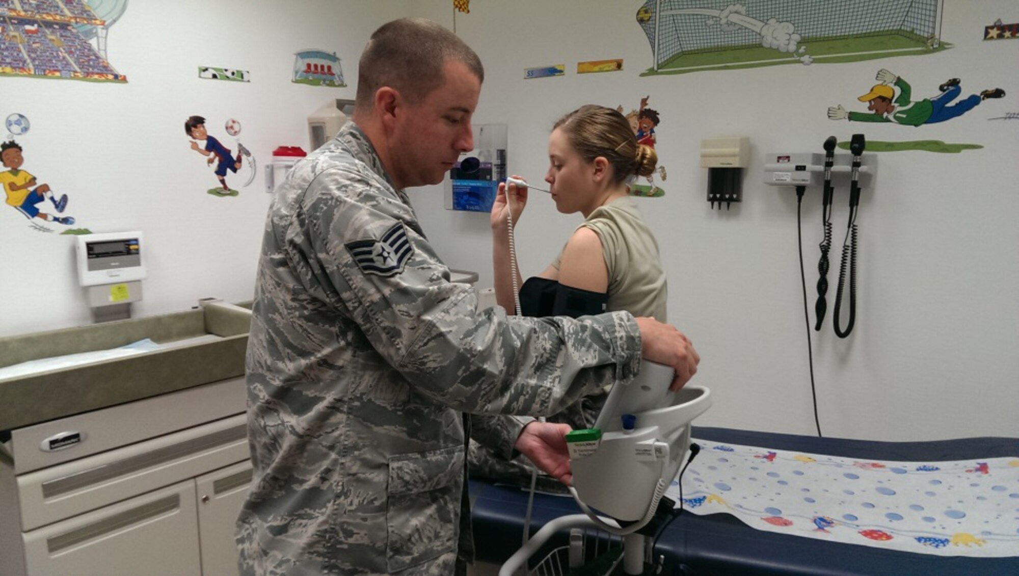 U.S. Air Force Technical Sergeant Ryan Folk, 192nd Medical Group Medical Technician, takes a patient’s vital signs in preparation for a routine examination.  The 192nd Medical Group sent 17 Airmen of varying specialties including doctors, nurses, medical technicians, physical therapists, logistic technicians and administrative support to the Spangdahlem Air Base, Germany Family Health Clinic July 14, 2014, where they treated approximately 275 patients and ensured active-duty military members and their families received quality health care this summer. (U.S. Air National Guard photo by Master Sgt. Samantha Mitchell/Released)